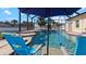 Pool with patio chairs and umbrellas at 2705 Lamkin Rd, North Port, FL 34288