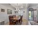 Bright dining room with wood table, chandelier, and view of backyard at 2705 Lamkin Rd, North Port, FL 34288