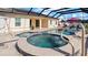 Spa with tiled accents and adjacent pool at 2705 Lamkin Rd, North Port, FL 34288