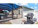 Gas grill on patio next to pool and fence at 2705 Lamkin Rd, North Port, FL 34288