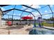 Covered patio with comfortable seating overlooking the pool at 2705 Lamkin Rd, North Port, FL 34288