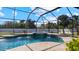 Screened pool area with spa and waterfall features at 2705 Lamkin Rd, North Port, FL 34288