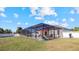 Spacious screened pool area with patio furniture and a large grassy yard at 2705 Lamkin Rd, North Port, FL 34288