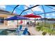 Covered patio with comfortable seating overlooking the pool at 2705 Lamkin Rd, North Port, FL 34288