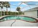 Inviting kidney-shaped pool with screened enclosure at 411 Scarlet Sage, Punta Gorda, FL 33955