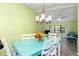 Bright dining area with teal table and white chairs, view into living room at 4290 Randypaar St, Port Charlotte, FL 33948