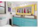 Bathroom with teal vanity, vessel sinks, and large mirror at 4290 Randypaar St, Port Charlotte, FL 33948