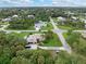 Aerial view of single Gathering home with tropical landscaping and driveway at 4290 Randypaar St, Port Charlotte, FL 33948