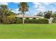 Landscaped backyard with tall hedge and palm tree at 4290 Randypaar St, Port Charlotte, FL 33948