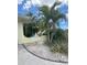 Well-maintained front yard with tropical landscaping, including palm trees and decorative gravel at 4290 Randypaar St, Port Charlotte, FL 33948