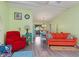 Open living room with colorful furniture and wood-look floors at 4290 Randypaar St, Port Charlotte, FL 33948