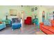 Open living room with colorful furniture and wood-look floors at 4290 Randypaar St, Port Charlotte, FL 33948