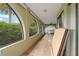 Spacious screened porch with arched windows and a ceiling fan at 4290 Randypaar St, Port Charlotte, FL 33948
