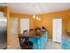 Kitchen with teal cabinets, granite island, and orange walls at 4290 Randypaar St, Port Charlotte, FL 33948