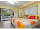 Bright bedroom with king-size bed and sliding doors leading to a patio at 4290 Randypaar St, Port Charlotte, FL 33948