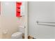 Small bathroom with toilet and red shelving; some demo work in progress at 440 Norma Ct, Punta Gorda, FL 33950