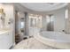 Spa-like bathroom with soaking tub and marble floors at 4601 Grassy Point Blvd, Port Charlotte, FL 33952