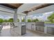 Luxury outdoor kitchen with stainless steel appliances and a built-in refrigerator at 4601 Grassy Point Blvd, Port Charlotte, FL 33952