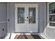 Beautiful glass double door entrance with an entry rug and views into the home at 5198 White Ave, Port Charlotte, FL 33981