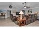 Comfortable living room featuring plush seating, a ceiling fan, and ample natural light at 5198 White Ave, Port Charlotte, FL 33981