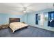 Main bedroom with a large bed and blue walls at 5950 Cypress Grove Cir, Punta Gorda, FL 33982