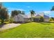 Single story home with metal roof, landscaping and driveway at 5950 Cypress Grove Cir, Punta Gorda, FL 33982