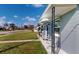 Gray house with a porch, black metal chairs, and white awnings at 8302 Aero Ave, North Port, FL 34287