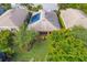 Aerial view of homes showcasing solar panels and backyard at 120 Cordana Ct, Venice, FL 34292