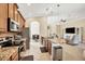Open concept kitchen with granite island and stainless steel appliances at 120 Cordana Ct, Venice, FL 34292