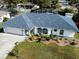 Single-story home with gray roof, white walls and blue accents at 1370 Kenmore St, Port Charlotte, FL 33952