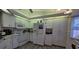 Bright kitchen featuring white appliances and ample cabinet space at 1370 Kenmore St, Port Charlotte, FL 33952