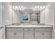 Double vanity bathroom with granite countertop and large mirror at 16138 Highgate St, Port Charlotte, FL 33953