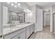 Bathroom with double vanity, granite countertop, and large mirror at 16138 Highgate St, Port Charlotte, FL 33953