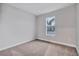 Simple bedroom with neutral walls, carpet, and a window at 16138 Highgate St, Port Charlotte, FL 33953