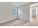 Bright bedroom with carpet flooring, double door closet, and access to a hallway at 16138 Highgate St, Port Charlotte, FL 33953