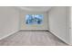 Bright bedroom with neutral carpeting and large window at 16138 Highgate St, Port Charlotte, FL 33953