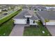 Attractive home with gray exterior, brick pavers, and palm trees at 16138 Highgate St, Port Charlotte, FL 33953