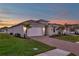 Two-car garage home with landscaped yard and brick driveway at 16138 Highgate St, Port Charlotte, FL 33953