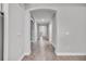 Long hallway with archways and wood-look tile flooring at 16138 Highgate St, Port Charlotte, FL 33953