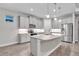 Kitchen with curved island, granite countertops, and stainless steel appliances at 16138 Highgate St, Port Charlotte, FL 33953