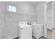 Laundry room with washer, dryer, and overhead shelving at 16138 Highgate St, Port Charlotte, FL 33953