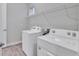Laundry room with washer, dryer, and overhead shelving at 16138 Highgate St, Port Charlotte, FL 33953