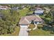 Aerial view of the home, driveway, and landscaping at 182 Santarem Cir, Punta Gorda, FL 33983