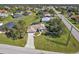 Aerial view of the home, surrounded by lush landscaping and mature trees at 182 Santarem Cir, Punta Gorda, FL 33983