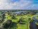 Aerial view of golf course and community with lake views at 182 Santarem Cir, Punta Gorda, FL 33983