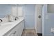 Bathroom with dual sinks, white cabinetry, and shower, offering a clean and modern design at 182 Santarem Cir, Punta Gorda, FL 33983