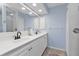 Bathroom with dual sinks, white cabinetry, and shower, offering a clean and modern design at 182 Santarem Cir, Punta Gorda, FL 33983