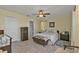 Bedroom with neutral walls, tile flooring, and a doorway leading to an adjacent bathroom at 182 Santarem Cir, Punta Gorda, FL 33983