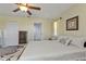 Bright bedroom with neutral tones, ceiling fan, and comfortable furnishings create a relaxing space at 182 Santarem Cir, Punta Gorda, FL 33983
