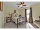Bedroom featuring a wrought iron bed frame, cozy bedding, and a window with natural light at 182 Santarem Cir, Punta Gorda, FL 33983